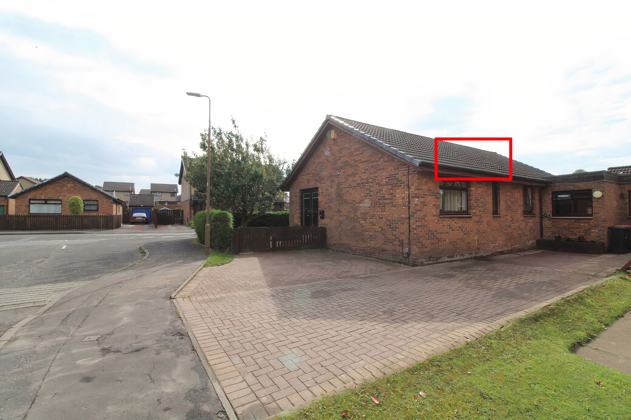 A photograph from the property's listing with the dip in roof outlined.